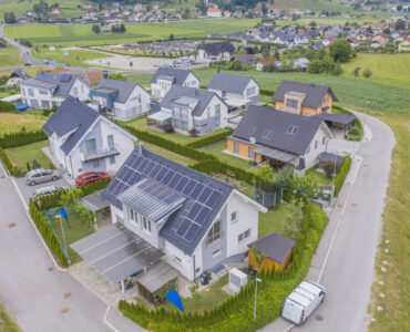 aerial-view-private-houses-with-solar-panels-roofs (1)