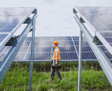 man-worker-firld-by-solar-panels (1)